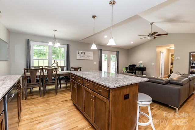 1005 8th Ave SW, Conover, NC 28613 - kitchen with light wood-style flooring, healthy amount of natural light, vaulted ceiling, dishwasher, and open floor plan