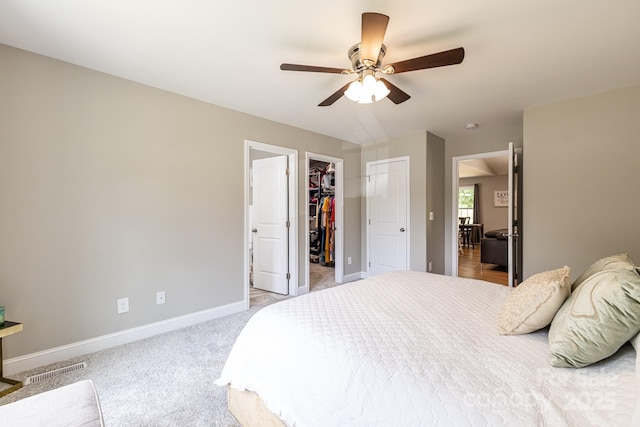 1005 8th Ave SW, Conover, NC 28613 - bedroom with a spacious closet, a ceiling fan, carpet, and a closet