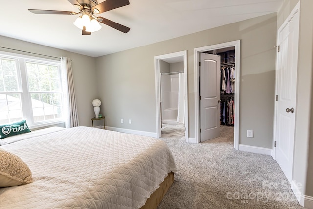1005 8th Ave SW, Conover, NC 28613 - bedroom with a walk in closet, carpet floors, a closet, ensuite bathroom, and ceiling fan