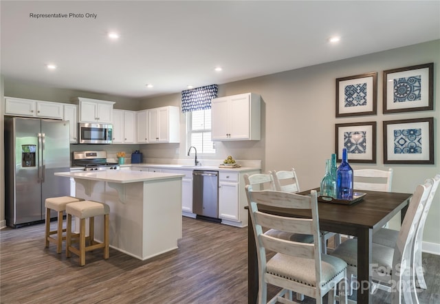 565 Nesbe St Unit 2220, Lancaster, SC 29720 - kitchen with appliances with stainless steel finishes, white cabinetry, a center island, dark wood-style floors, and light countertops