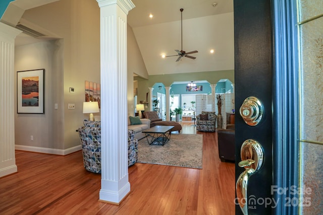 406 Spyglass Hill Pl, Salisbury, NC 28144 - living room with decorative columns, ceiling fan, arched walkways, wood finished floors, and high vaulted ceiling