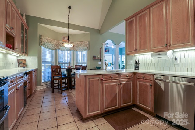 406 Spyglass Hill Pl, Salisbury, NC 28144 - kitchen with stainless steel dishwasher, light tile patterned floors, vaulted ceiling, a peninsula, and decorative backsplash