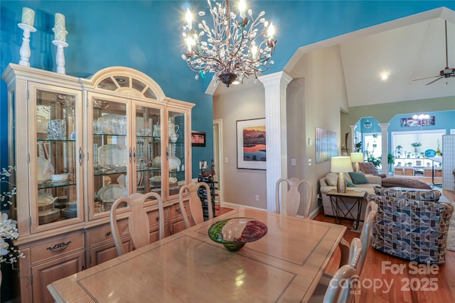 406 Spyglass Hill Pl, Salisbury, NC 28144 - dining room featuring a chandelier, high vaulted ceiling, ornate columns, ceiling fan, and wood finished floors