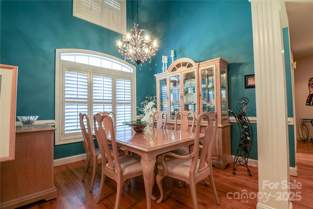 406 Spyglass Hill Pl, Salisbury, NC 28144 - dining area featuring a chandelier, wood finished floors, and a towering ceiling