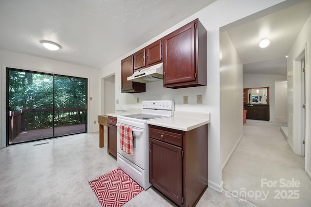 8416 Rittenhouse Cir, Charlotte, NC 28270 - kitchen featuring white range with electric cooktop, under cabinet range hood, light countertops, and reddish brown cabinets