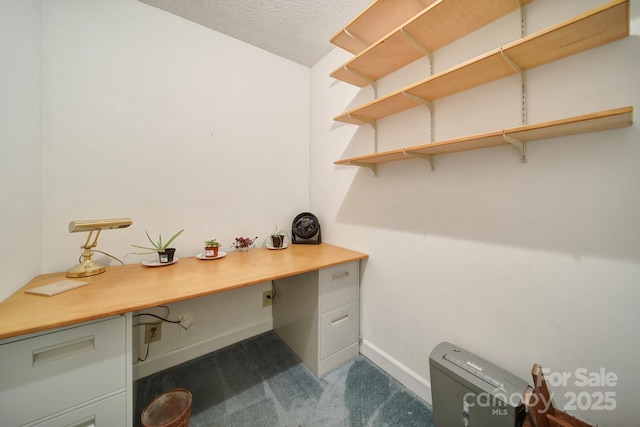 8416 Rittenhouse Cir, Charlotte, NC 28270 - home office featuring dark colored carpet, built in desk, and a textured ceiling