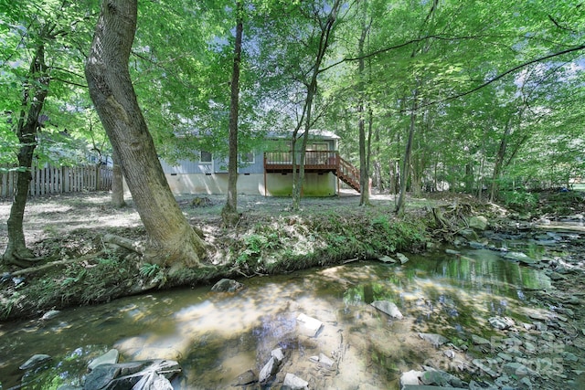 8416 Rittenhouse Cir, Charlotte, NC 28270 - view of yard featuring stairs, a deck, and a wooded view