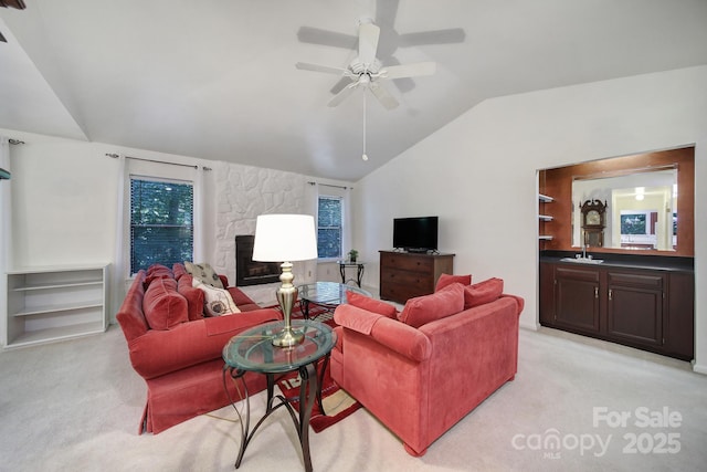 8416 Rittenhouse Cir, Charlotte, NC 28270 - living room with light carpet, lofted ceiling, a stone fireplace, and a ceiling fan