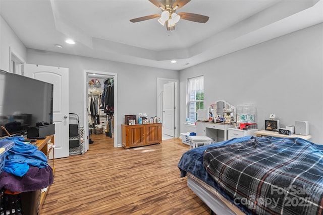 2953 Cameron Village Ct, Winston Salem, NC 27103 - bedroom featuring a tray ceiling, wood finished floors, recessed lighting, a spacious closet, and ceiling fan