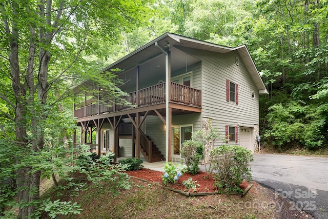 380 Allison Dr, Maggie Valley, NC 28751 - view of front of home featuring driveway, an attached garage, a wooden deck, and stairs