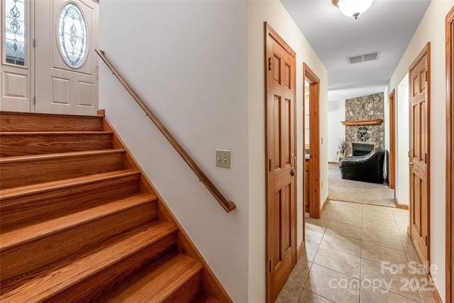 380 Allison Dr, Maggie Valley, NC 28751 - stairway with a stone fireplace, tile patterned flooring, and carpet