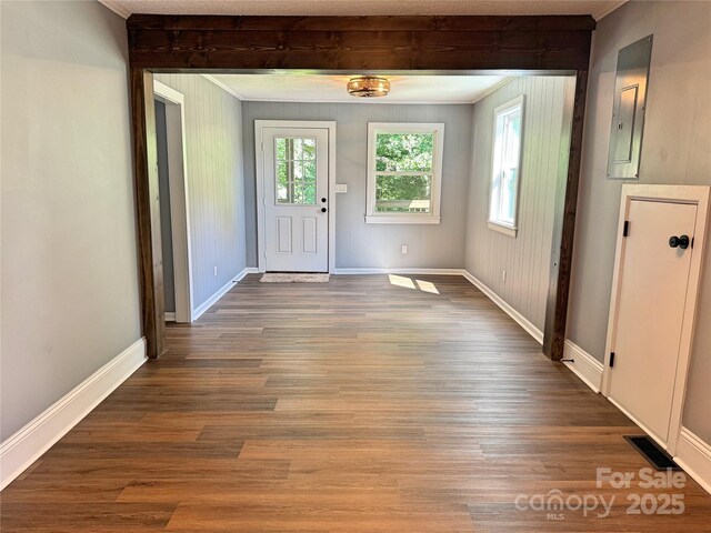 201 Barnes Ln, Stony Point, NC 28678 - foyer entrance featuring electric panel, healthy amount of natural light, wood finished floors, beamed ceiling, and crown molding