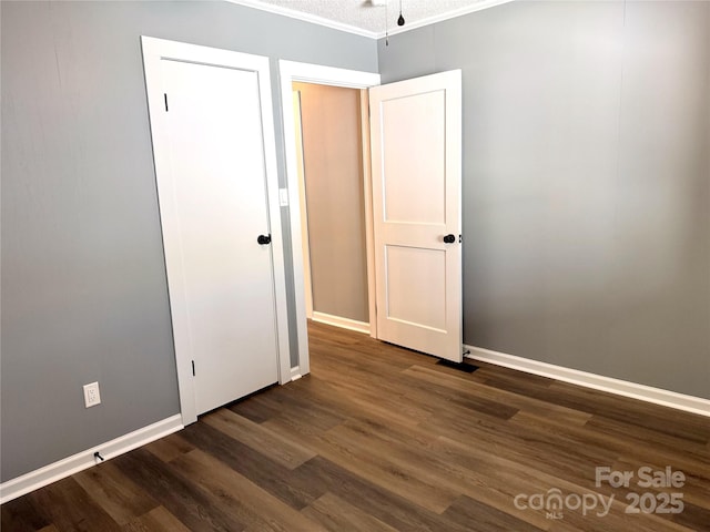 201 Barnes Ln, Stony Point, NC 28678 - unfurnished bedroom with dark wood-type flooring and baseboards