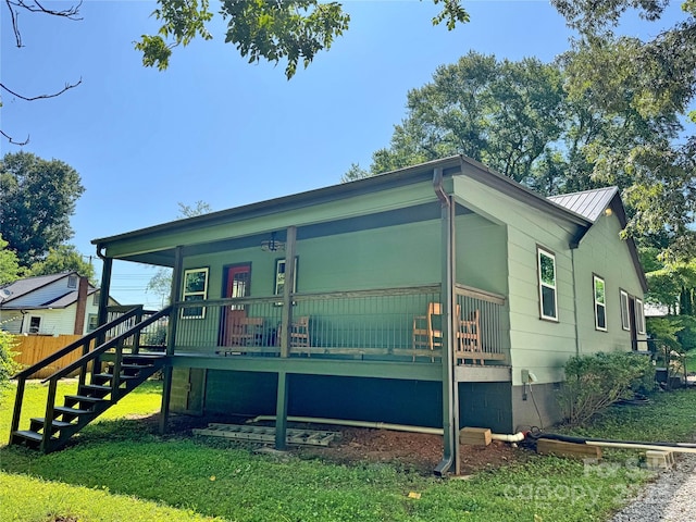 201 Barnes Ln, Stony Point, NC 28678 - view of front of house featuring a porch, stairs, crawl space, a front yard, and a metal roof