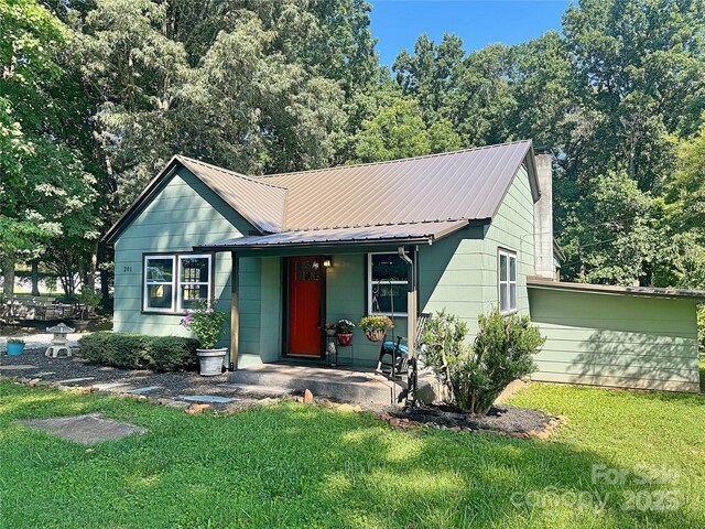 201 Barnes Ln, Stony Point, NC 28678 - single story home featuring a front yard, a chimney, covered porch, and a metal roof