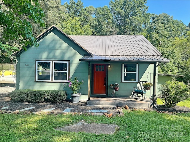 201 Barnes Ln, Stony Point, NC 28678 - view of front of home featuring a porch, a metal roof, and a front yard