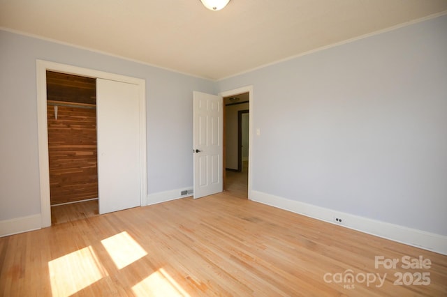 7645 Robinson Church Rd, Harrisburg, NC 28075 - unfurnished bedroom with crown molding, a closet, and wood finished floors