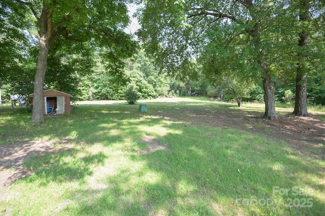 7645 Robinson Church Rd, Harrisburg, NC 28075 - view of grassy yard featuring a shed