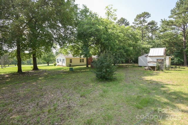 7645 Robinson Church Rd, Harrisburg, NC 28075 - view of grassy yard featuring an outdoor structure and view of scattered trees