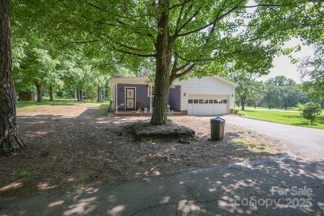 7645 Robinson Church Rd, Harrisburg, NC 28075 - view of front of home featuring driveway, a garage, and a chimney
