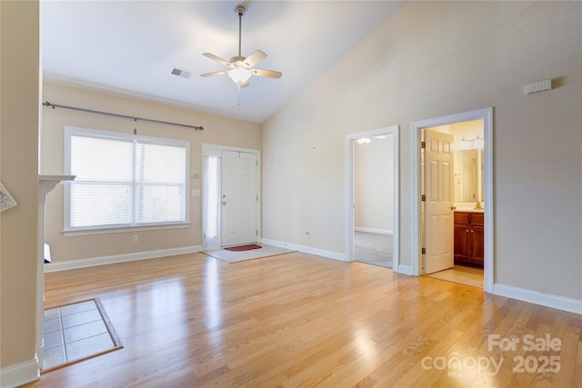 2785 Clover Rd NW, Concord, NC 28027 - unfurnished living room featuring a ceiling fan, light wood-style floors, and high vaulted ceiling