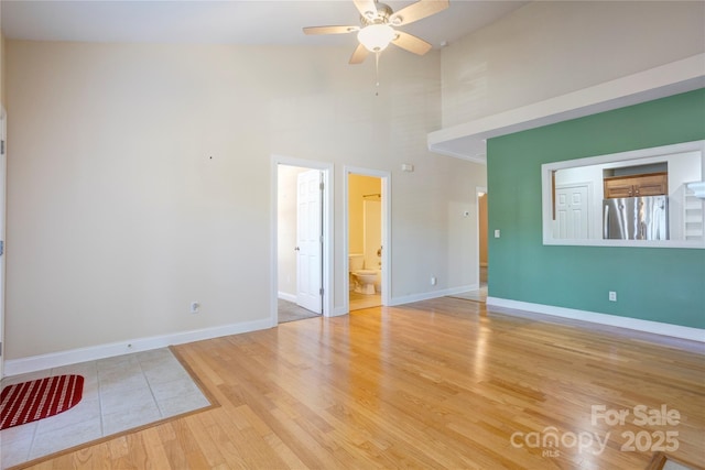 2785 Clover Rd NW, Concord, NC 28027 - empty room featuring wood finished floors, a high ceiling, and ceiling fan
