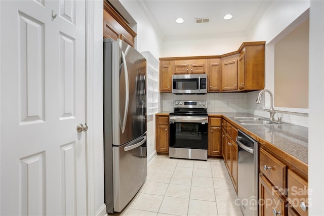 2785 Clover Rd NW, Concord, NC 28027 - kitchen with appliances with stainless steel finishes, brown cabinets, light tile patterned flooring, ornamental molding, and tasteful backsplash