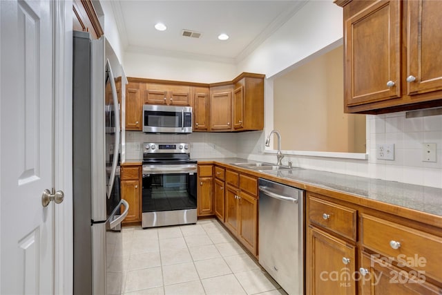 2785 Clover Rd NW, Concord, NC 28027 - kitchen featuring stainless steel appliances, brown cabinetry, light tile patterned flooring, decorative backsplash, and crown molding