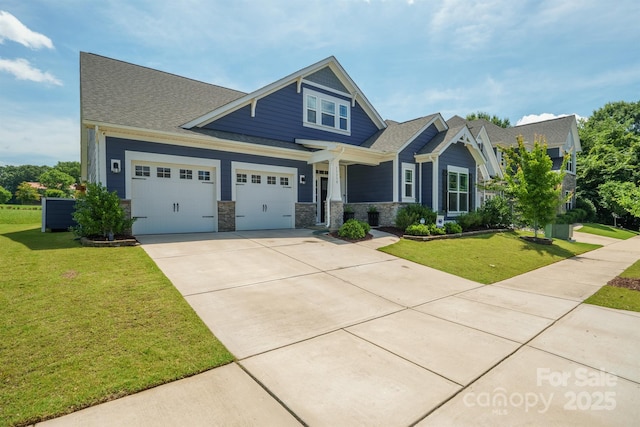 13339 Mcguffy Dr, Huntersville, NC 28078 - craftsman-style house featuring driveway, a front lawn, stone siding, a shingled roof, and a garage