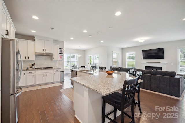 13339 Mcguffy Dr, Huntersville, NC 28078 - kitchen featuring appliances with stainless steel finishes, healthy amount of natural light, white cabinetry, light stone counters, and recessed lighting