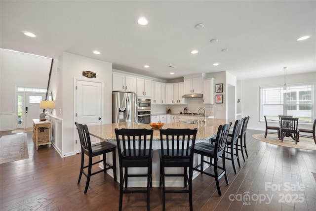 13339 Mcguffy Dr, Huntersville, NC 28078 - dining room with healthy amount of natural light, dark wood finished floors, and recessed lighting