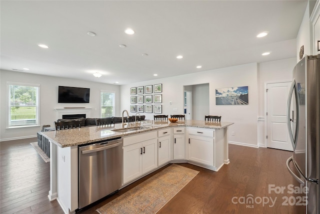 13339 Mcguffy Dr, Huntersville, NC 28078 - kitchen featuring stainless steel appliances, dark wood finished floors, recessed lighting, plenty of natural light, and light stone counters