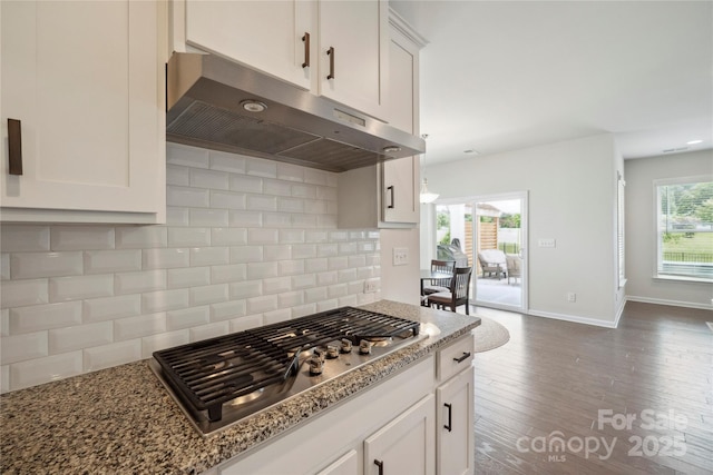 13339 Mcguffy Dr, Huntersville, NC 28078 - kitchen featuring under cabinet range hood, stainless steel gas cooktop, tasteful backsplash, light stone counters, and white cabinets