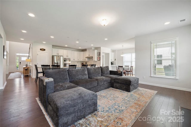 13339 Mcguffy Dr, Huntersville, NC 28078 - living area featuring dark wood-type flooring, healthy amount of natural light, and recessed lighting