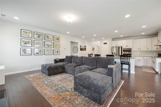13339 Mcguffy Dr, Huntersville, NC 28078 - living room featuring dark wood-type flooring and recessed lighting