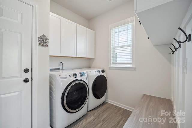 13339 Mcguffy Dr, Huntersville, NC 28078 - laundry area with cabinet space, washer and clothes dryer, and light wood finished floors