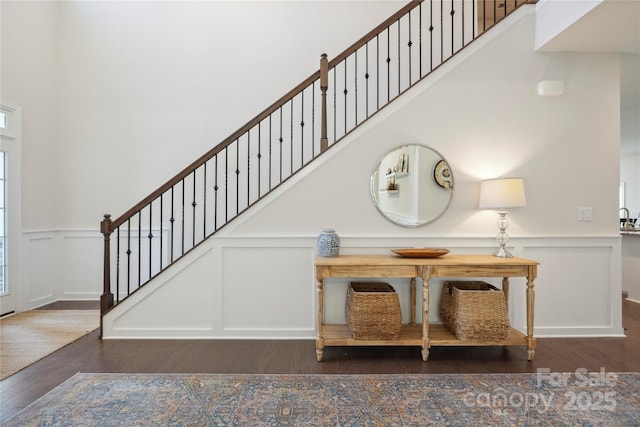 13339 Mcguffy Dr, Huntersville, NC 28078 - stairs featuring a decorative wall, wood finished floors, wainscoting, and a high ceiling