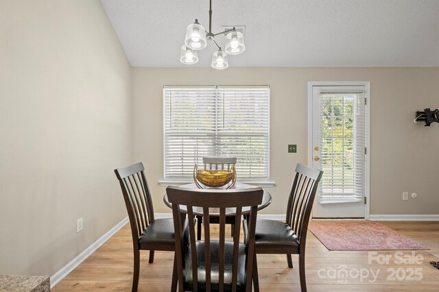 121 Gilcrest Ln, Troutman, NC 28166 - dining room with a chandelier and light wood-style flooring