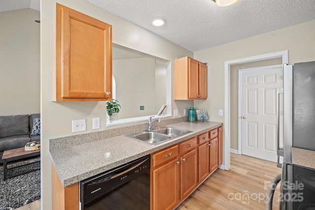 121 Gilcrest Ln, Troutman, NC 28166 - kitchen featuring black appliances, light wood finished floors, light countertops, and a textured ceiling