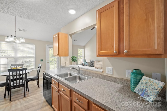 121 Gilcrest Ln, Troutman, NC 28166 - kitchen featuring black dishwasher, light wood-type flooring, a textured ceiling, brown cabinets, and pendant lighting