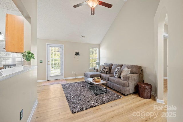 121 Gilcrest Ln, Troutman, NC 28166 - living area featuring ceiling fan, light wood-type flooring, arched walkways, and high vaulted ceiling