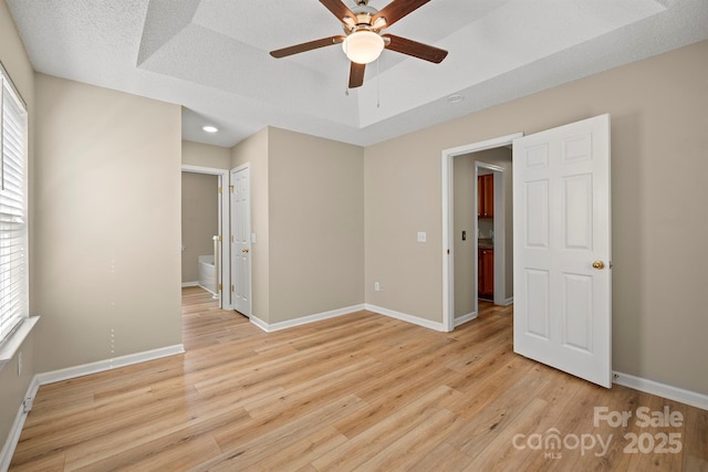121 Gilcrest Ln, Troutman, NC 28166 - empty room with a ceiling fan, light wood-style floors, recessed lighting, and a raised ceiling