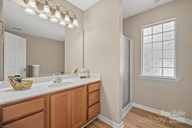 121 Gilcrest Ln, Troutman, NC 28166 - full bath with wood finished floors, a shower stall, and vanity