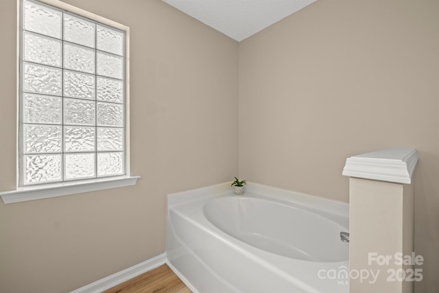 121 Gilcrest Ln, Troutman, NC 28166 - bathroom with a bath and wood finished floors