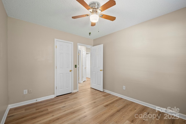 121 Gilcrest Ln, Troutman, NC 28166 - unfurnished bedroom featuring light wood-style flooring, a ceiling fan, and a textured ceiling