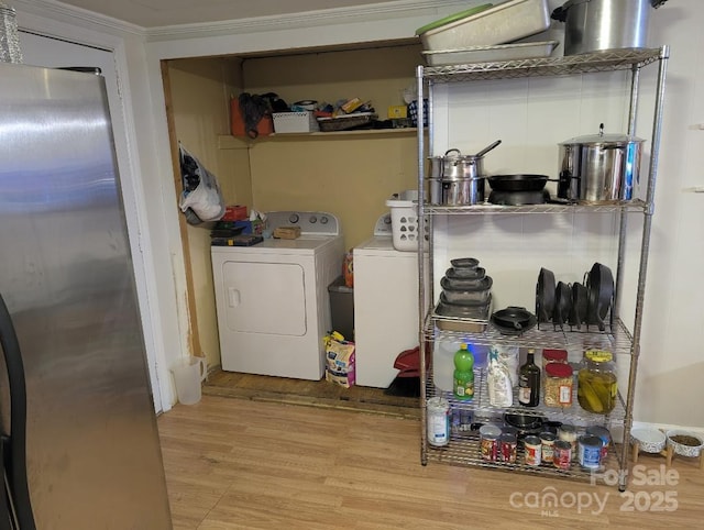 2261 Felly Ln, Lancaster, SC 29720 - laundry room featuring wood finished floors, washer and dryer, and crown molding