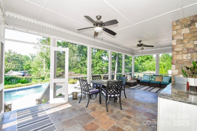 711 Yadkin St, Albemarle, NC 28001 - sunroom / solarium with an outdoor hangout area, a ceiling fan, and outdoor dining space
