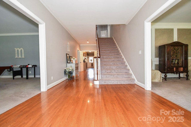 711 Yadkin St, Albemarle, NC 28001 - carpeted entryway with stairway, crown molding, and wood finished floors