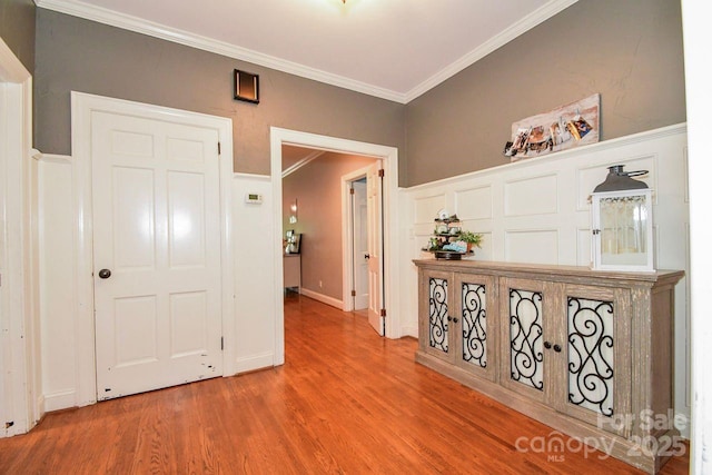 711 Yadkin St, Albemarle, NC 28001 - corridor with wood finished floors, ornamental molding, a decorative wall, and wainscoting