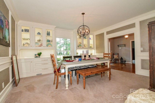 711 Yadkin St, Albemarle, NC 28001 - dining space with a chandelier, crown molding, and light colored carpet